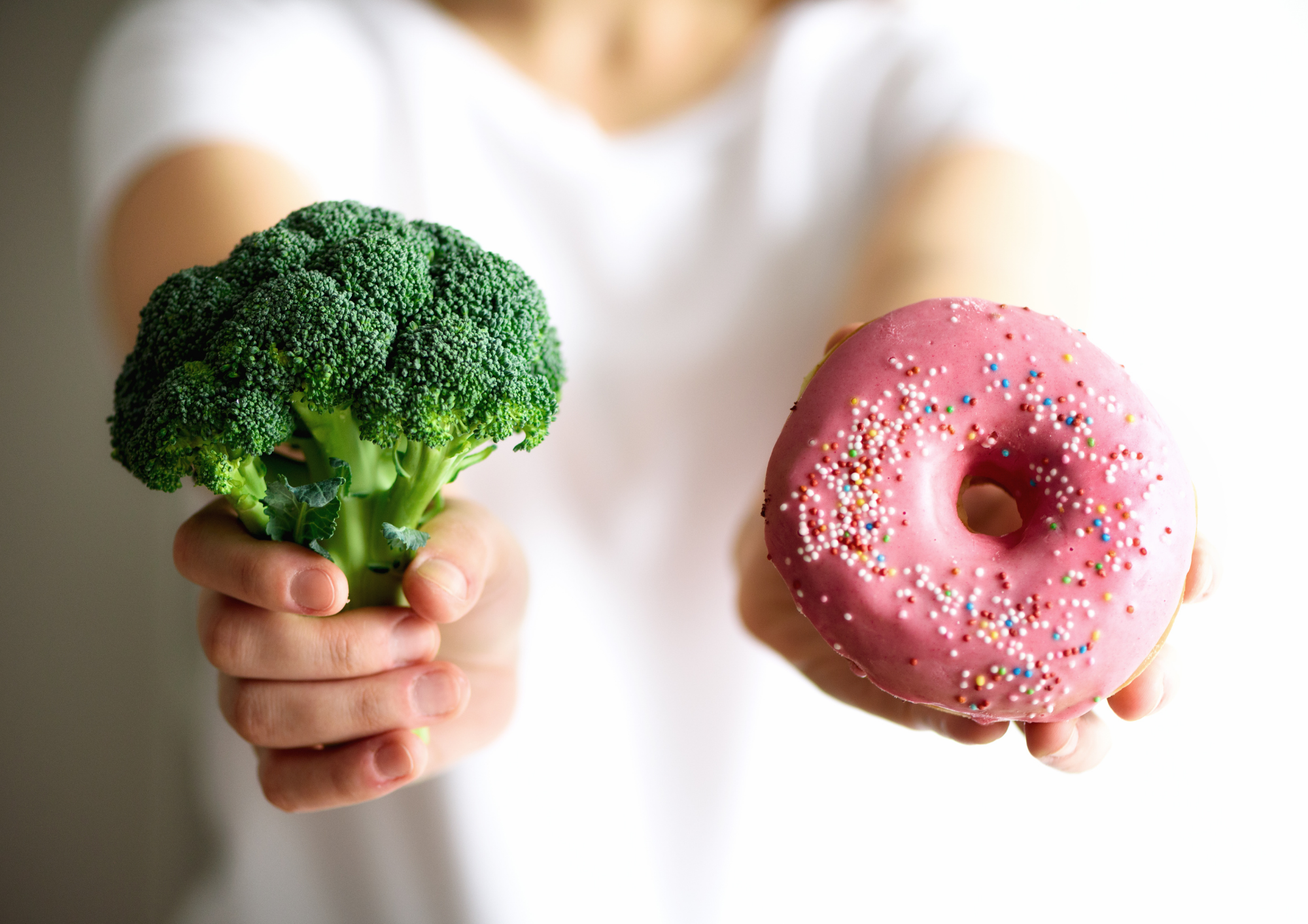 Choice between healthy broccoli and unhealthy doughnut